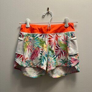 Athleta Girl Shorts - Multicolor leaf pattern, orange waistband.
